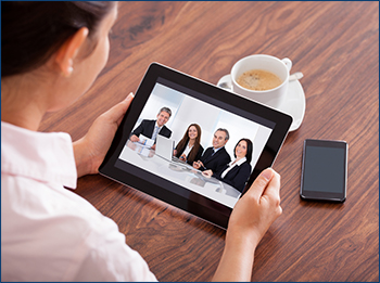 Person viewing a meeting on a tablet.